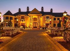 a large house with christmas lights on it's front yard and walkway leading to the entrance