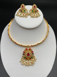 Unique style kante with navarathna Stones pendant and matching earrings Handmade jewelry One gram gold jewelry Silver plated jewelry Official Website globusfashions.com 🌸 S H O P . M O R E . S T Y L E S 🌸 https://www.etsy.com/shop/Globusfashions Necklaces - https://www.etsy.com/shop/Globusfashions?section_id=18712263 Bracelets - https://www.etsy.com/shop/Globusfashions?section_id=18969767 Pendant Sets - https://www.etsy.com/shop/Globusfashions?section_id=18707402 Tikka - https://www.etsy.com/s Gold Plated Temple Jewelry Set For Puja, Gold Plated Temple Jewelry Sets, Temple Jewelry Style Gold Plated Jewelry Sets For Celebration, Gold Plated Temple Jewelry Sets For Celebration, Temple Style Gold Plated Jewelry Sets For Celebration, Festive Temple Jewelry Sets For Celebration, Festive Celebration Temple Jewelry Sets, Temple Jewelry Sets With Latkans For Celebration, Gold Plated Temple Necklace For Celebrations And Festivals