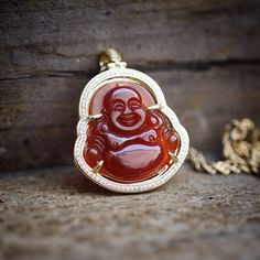 Hip Hop Red Agate Green Jade Buddha Necklace. Chain Is 14k Gold Plated Over 316 Stainless Steel. Pendant Size Is 35mm In Length (Small). Comes 2 Mm Width 20,22 Or 24 Inch Length 14k Gold Plated 316 Stainless Steel Rope Chain. Elegant Red Agate Necklace, Red Round Agate Jewelry, Red Carnelian Spiritual Jewelry, Red Agate Gemstone Necklace, Red Agate Pendant Necklace, Yellow Gold Agate Necklace As Gift, Yellow Gold Agate Necklace For Gift, Yellow Gold Agate Jewelry Gift, Yellow Gold Agate Jewelry For Gift