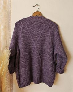 Dried winter lavender tones pair with the softest nubby textured knit. Designed with a cardigan fit, front pockets and a slouchy cozy fit. Perfect for staying cute in chilly weather. Cozy oversized fit Color: Dusty lavender Cotton & Acrylic Blend Hand wash cold Small Medium Large Bust 47 48 49 Waist 47 48 49 Hips 47 48 49 Length 29 29 29 Bust, waist, and hip measurements are a total circumference. Length is measured from the top of the shirt to the hem. Measurements are an estimate. Cozy Lavender Sweater For Fall, Cozy Lavender Sweater For Winter, Winter Lavender, Purple Cozy Knit Sweater, Cozy Lavender Winter Sweater, Purple Hand-knitted Winter Sweater, Lavender Cotton, Lavender Sweater, Dusty Lavender