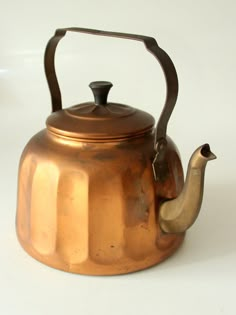 an old tea kettle with a metal handle