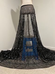 a black and blue dress with sequins on it