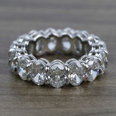 a diamond ring sitting on top of a wooden table