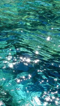 the water is very clear and blue with little white dots on it's surface