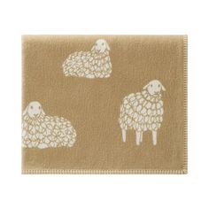 a brown and white rug with sheep on it