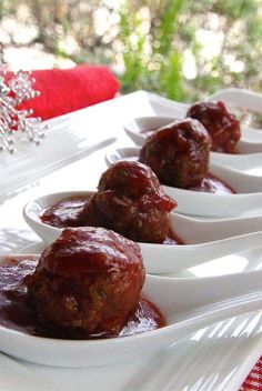 meatballs with sauce in small white dishes on a red and white tableclothed cloth