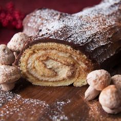 there is a chocolate roll with nuts on the table