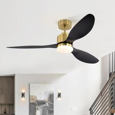 a ceiling fan that is mounted to the ceiling in a living room with white walls