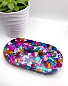 a glass tray sitting next to a potted plant