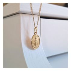 This beutiful oval shaped Miraculous Medal is made with 18 kt gold plating sterling silver. Medal is satin texture with diamond cut edges. Technique of making this medal is minting ( coining ) so it is very detailed. Item deatils:  Dimensions of medal is 25 mm or  (0'98 inch) x 11 mm(0,48 inch).  Weight of medal: 1, 8 gr. Available necklace lengths: 42 cm (16, 5 inch), 50 cm (19,7 inch) and 60 cm ( 23,6 inch). This size of medal is ideal for teenage girls or women that prefers miniature Miraculo Gold Hallmarked Oval Cabochon Necklaces, Gold Engraved Oval Cabochon Necklace, Elegant Oval Miraculous Medal Jewelry, Spiritual Miraculous Medal Oval Pendant Jewelry, Spiritual Oval Pendant Jewelry With Miraculous Medal, Spiritual Oval Jewelry For Commemoration, Oval Spiritual Jewelry For Commemoration, Oval Miraculous Medal Jewelry For Commemoration, Elegant Oval Necklace With Miraculous Medal