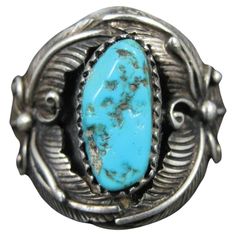 This gorgeous Southwestern ring is an unsigned beauty. Measurements: The face of the ring measures 15/16 of an inch from knuckle to knuckle. The turquoise measures 7x15mm. The ring is a size 9. Marks: Sterling Feather Ring, Native American Turquoise, Southwest Art, American Turquoise, La Face, Turquoise Rings, The Ring, Sterling Ring, Fashion Rings