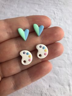 two small white and blue heart shaped studs