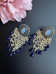 These earrings come in 3 different beautiful colors with a handmade vintage look. It comes in Blue, red, and gray tone and has small beads/pearls as addition to create a statement look. They are gorgeous for a night out and elegant for any outfit as this is a very unique piece and can be paired with many colors. Perfect for gifting and for anyone that loves jewelry, this pair of earrings is sure to leave a mark! Traditional Pearl Earrings With Dangling Beads For Party, Elegant Pearl Earrings With Dangling Beads For Festivals, Elegant Blue Jhumkas With Latkans, Festive Fusion Blue Earrings, Elegant Beaded Earrings With Dangling Beads For Festive Occasions, Beaded Latkans Earrings For Party And Festivals, Elegant Beaded Earrings With Dangling Beads For Festivals, Elegant Dangling Beads Earrings For Festivals, Blue Dangling Beads Earrings For Wedding