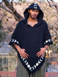 "\"Stay cozy and stylish with the Amavasi Poncho. Made from soft and durable cotton, and featuring a unique blockprint border depicting the phases of the moon, this poncho is perfect for adding a touch of boho to any outfit. Don't forget the convenient hoodie for those chilly nights. Bring on the moon magic!\"" Long Poncho, Wool Poncho, Phases Of The Moon, Hooded Poncho, Moon Magic, On The Moon, Stay Cozy, Ponchos, The Moon