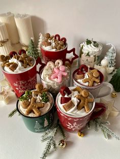 several mugs filled with different types of food and decorations on top of a table