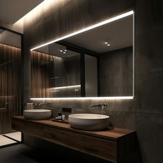 a bathroom with two sinks and a large mirror above it's countertop area