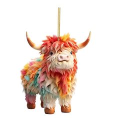 a colorful cow ornament hanging from a rope