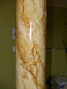 a marble column in the corner of a room