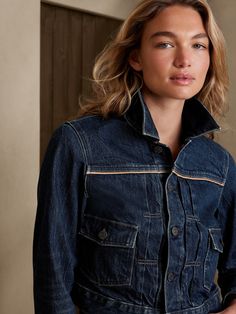 A timeless treasure to travel the world, this sturdy denim jacket is made from a sumptuous blend of new and organic cotton, with vegan leather piping at the seams and pockets for added pop.  WARM: Unlined and perfect for layering.  FROM ITALY'S CANDI Fall Cotton Denim Jacket With Contrast Stitching, Fall Denim Blue Outerwear With Contrast Stitching, Denim Blue Outerwear With Contrast Stitching For Fall, Classic Denim Jacket With Contrast Stitching, Denim Blue Jacket With Contrast Stitching For Fall, Fitted Denim Outerwear With Contrast Stitching, Fitted Denim Jacket With Contrast Stitching And Long Sleeves, Fitted Denim Jacket With Contrast Stitching, Dark Wash Denim Jacket With Contrast Stitching For Work