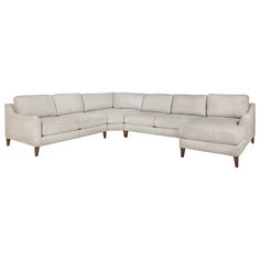 a white sectional couch with wooden legs