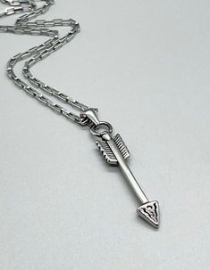 Stainless Steel Arrow Pendant Necklace ~ CHOOSE YOUR CHAIN ~ Non Tarnish ~ Antique Silver Arrowhead ~ Women Men Unisex Teen Jewelry Gift ~ Fun Fashion On The Go * 304 stainless steel (all chains & pendant) * Chain styles:  3.5mm oval link (mini paperclip);  2.5mm rolo;  2.5mm round box (venetian);  2mm square box;  2mm satellite bead chain;  2mm cable chain * Lengths:  14";  15";  16;  17";  18";  20";  22";  24";  26"  (measurement include clasp & chain) * Optional 2" extender on satellite & cable chains  * Add "note to seller" with order to add extender to any chain * Pendant:  44.5mm x 8.5mm * Closure:  lobster claw clasp * Tarnish resistant; waterproof Please, message me with any questions or to REQUEST a custom length! All items ship within 24 - 48 hrs (excluding Sundays & holidays). Arrow Pendant Necklace, Southwestern Boho, Teen Jewelry, Arrow Pendant, Round Box, Bead Chain, Unisex Jewelry, Fun Fashion, Chain Pendant