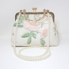 New to our Millennium collection, This beautiful romantic WHITE Embroidered LACE FLORAL bridal clutch bag is made of very fine quality of fabric and metal and it comes with a two long Detachable chain one is pearl chain and other is metal chain of your choice for your Big day! Dimensions- length oh the bag is 6.5 inches and width of the bag is 9 inches. Pearl chain measure about 43 inches and Gold Metal chain about 47 inches long. ► ABOUT YOUR ORDER * All items are neatly packaged in our beautiful jewelry boxes and elegant organza bags. * All items are 100% gift-ready. * Each order comes with a personalized handwritten card and a branded Millennium Bride jewelry cloth. * Each order comes with a free gift. ► PERSONALIZTION * If your order is a gift, you may contact us with the recipient's n White Evening Bag With Detachable Handle For Events, White Shoulder Bag With Detachable Handle For Wedding, White Embroidered Rectangular Evening Bag, Formal White Embroidered Clutch, White Embroidered Handheld Evening Bag, White Feminine Evening Bag For Wedding, Feminine White Evening Bag For Wedding, Feminine Beige Wedding Bags, Elegant Handheld Embroidered Shoulder Bag