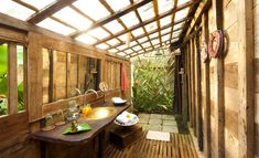 an outdoor bathroom with wooden walls and flooring