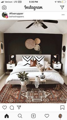 a bed room with a neatly made bed next to a ceiling fan and two planters