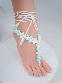 Very cute barefoot sandals that are available in two colors of either turquoise or purple.  Sandals have turquoise, purple, white or clear plastic pony beads that are woven with a white cording.  Cording will wrap around the ankle two to three times depending on the size of your angle.  Once the cord is wrapped around the ankle tie a bow and pull tight to secure the bow.  There are pony beads on the ends that dangle down. Photo #5 shows how they would look with a pair of thong style sandal shoes White Bohemian Barefoot Sandals With Ankle Wrap, Handmade White Barefoot Sandals For Beach, White Handmade Bohemian Barefoot Sandals, Handmade White Bohemian Barefoot Sandals, Adjustable Toe Ring Barefoot Sandals For Summer, White Bohemian Handmade Barefoot Sandals, Adjustable Ankle Wrap Barefoot Sandals For Summer, White Bohemian Toe Ring Barefoot Sandals, White Bohemian Barefoot Toe Ring Sandals