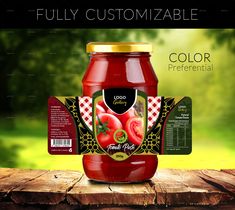 a jar of tomato sauce sitting on top of a wooden table next to a green field