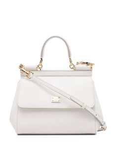 White leather small Sicily tote bag from DOLCE & GABBANA featuring textured finish, gold-tone logo plaque, front flap closure, magnetic fastening, single rounded top handle, adjustable detachable shoulder strap, internal slip pocket and internal logo stamp. | Dolce & Gabbana small Sicily tote bag Sicily Bag, Lizard Skin, Girly Bags, Fancy Bags, Dolce E Gabbana, Logo Stamp, Trendy Accessories, Handle Bag, White Bag