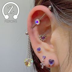 an ear piercing with several different colored stones