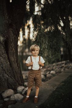 My current processing time is 3-4 weeks before shipping. Please do not order if you need your item(s) before then :)  **Photos by Elsie Smith of This Moment Photography** If you're looking for the perfect vintage style outfit for your little guy, look no further! These brown linen suspender shorts are perfect for weddings, baptisms, holidays, christenings, family photos, or dressed down for everyday wear.  They are made of a soft linen blend with a luxurious texture, and feature a flat front, for a classic tailored fit, and elastic in the back waistband. The suspender straps button on to the shorts in the front and back, and have two buttonholes in the back to be able to adjust for longer wear. A velvet ribbon strip where the suspenders cross keeps the straps from slipping off of the shoul Vintage Outfits Boys, Toddler Wedding Outfit Boy, Boys Wedding Outfit, Baby Boy Wedding Outfit, Boys Ring, Baby Boy Easter Outfit Infants, Ring Bearer Boy, Wedding Outfit For Boys