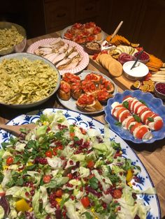 a table full of food including salads and appetizers