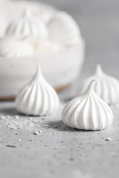 three pieces of meringue sitting on top of a table next to a doughnut