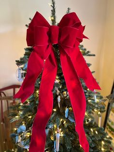 a decorated christmas tree with red bows