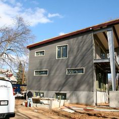 a truck parked in front of a house under construction