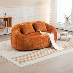 a living room filled with furniture and a white rug