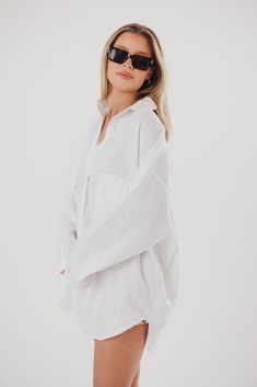 It's true that you can't have too many button-up shirts - and the Marion is SO worth adding to your collection. This gorgeous 100% cotton shirt features a very relaxed silhouette, perfect for wearing over a brami and cut-offs, as a swim coverup, or partly buttoned with loose linen pants. This is a must-have for effortless and understated elegance. FIT: Runs oversized. MATERIAL: 100% Cotton. GARMENT DETAILS: 100% cotton button-up shirt. Features collared neckline, front button placket, and long b Effortless Oversized Button-up Tops, Oversized Effortless Shirt With Shirttail Hem, Relaxed Shirt With Shirttail Hem For Day Out, Relaxed Fit Shirt With Shirttail Hem For Day Out, Oversized Shirttail Hem Shirt For Day Out, Oversized Shirt With Shirttail Hem For Day Out, Oversized Button-up Shirt For Loungewear, Classic Oversized Linen Tops, Effortless Shirt With Shirttail Hem For Day Out