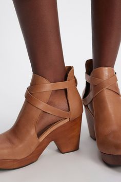 Embrace your boho spirit in these luxe leather clogs, featuring a genuine cedar wood platform sole with an ankle cutout and strappy accents. **Features:** Slip-on style, ankle length, round toe, leather uppers, ankle cutouts, criss-cross straps with adjustable buckle closure, platform cedar wood sole, block heel **Why We | Cedar Leather Clogs by FP Collection at Free People in Tan, Size: US 9 Chic Leather Clogs With Ankle Strap, Spring Leather Clogs With Wrapped Heel, Leather Clogs With Wrapped Heel And Closed Toe, Leather Closed Toe Clogs With Wrapped Heel, Natural Round Toe Heels With Stacked Heel, Natural Heels With Stacked Heel And Round Toe, Natural Color Heels With Stacked Heel And Round Toe, Chic Natural Leather Heels, Natural Leather Heels With Stacked Heel