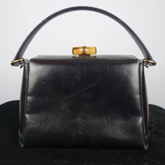 Vintage Gucci Black Leather Bamboo Turnlock Top Handle Bag With Crossbody Strap Made In Italy. * Tracking Number Included * Sourced From The Reuse Sector. Size - Small Suggestions - Collector's Item - Casual & Formal Item Condition Please Understand That Since These Items Are Vintage And/Or Recycled, They May In Fact Show A Little Sign Of Wear, Aging, Or Slight Discoloration. If We List Something As New Old Stock (Nos) Or New, It Will Be In Excellent Condition. Any Other Characterization Is Subj Chic Gucci Shoulder Bag With Bamboo Handle, Vintage Gucci Evening Bags, Classic Gucci Bag With Bamboo Handle, Vintage Gucci Top Handle Shoulder Bag, Vintage Gucci Top Handle Bag, Classic Evening Shoulder Bag With Bamboo Handle, Evening Leather Shoulder Bag With Bamboo Handle, Leather Shoulder Bag With Bamboo Handle For Evening, Gucci Rectangular Satchel For Evening