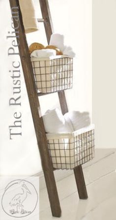 a ladder that has baskets on it and towels in the bottom basket, next to a towel rack