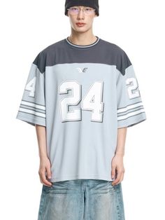 It is a short sleeves football jersey that is made of moisture-wicking and breathable fabric. The t-shirt has colorblock design and graphic print on the sleeves and front. The balloon oversized fit t-shirt makes casual and stylish outfit.- Balloon oversized fit- Stripes on sleeves- Graphic print- Stripe point on neck Blue Varsity Short Sleeve Jersey, Sporty White T-shirt With Number Print, Blue Short Sleeve Varsity Jersey, Blue Jersey T-shirt For Football Season, White Sports T-shirt With Number Print, Casual Number Print T-shirt For Streetwear, Blue Short Sleeve Baseball Jersey, White Jersey For Streetwear During Football Season, Casual Jersey T-shirt For Game Day