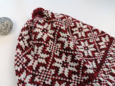 Knitted winter hat, pure wool. Size as medium, matching for the head 56-58 cm. Snowflake pattern - etnic design from Estonia, Kihnu troi pattern. 100% lambs wool, without lining. This hat is unique - unisex model. Very good matching to men and women the same. Wonderful warm winter hat for men. Knitted with the best lambs wool. The hat keeps you dry and warm, in the cold and windy winter time. There is used 2 colour combined white pattern: red or grey model. You can order the hat with pom pom or Winter Fair Isle Pattern Beanie Hat, Fair Isle Beanie Hats For Winter, Winter Beanie Patterns, One Size Fits Most, Winter Fair Isle Beanie Hats, One Size Fits Most Winter Beanie Pattern, Nordic Knitted Winter Beanie, Nordic Knitted Beanie For Winter, Nordic Knitted Winter Hat, Nordic Style Hand Knitted Winter Hat