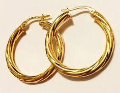 Fancy style, swirly hoop earrings:metal        : solid 14k yellow goldcast           : hollowweight      = 2.3 grdiameter  = 1.25"inch (30mm)thick          = 3 mmclosure      : snap downmade         : in Italy Modern Twist Small Hoop Jewelry Gift, Modern Twist Small Hoop Earrings For Gift, Modern Twist Small Hoop Earrings As Gift, Modern Twist Hypoallergenic Hoop Earrings As Gift, Modern Twist Hypoallergenic Hoop Earrings For Gifts, Modern Twist Yellow Gold Hoop Earrings As Gift, Elegant Spiral Hoop Earrings As Gift, Elegant Spiral Hoop Earrings For Gift, Elegant Cadmium-free Hoop Earrings As Gift