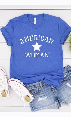 American Woman, USA, America, Independence Day, 4th of July, Patriotic Graphic Tee with white InkMade In: USAFabric Contents: Most t-shirt colors are 52/48 cotton/polyester blend. Athletic Heather & Black Heather are 90/10 cotton/polyester. White, cream, citron, pink, canvas red, lilac, mint are 100% cotton. Ash is 99/1. Blue Screen Print Tops In Ring-spun Cotton, Comfortable Blue Letter Print Top, Blue Ring-spun Cotton Tops With Screen Print, Blue Letter Print Top With Comfortable Fit, Casual Blue Ring-spun Cotton Top, Blue Ring-spun Cotton Top With Screen Print, Blue Tops With Letter Print And Comfortable Fit, Trendy Blue Soft-washed T-shirt, Trendy Soft-washed Blue T-shirt