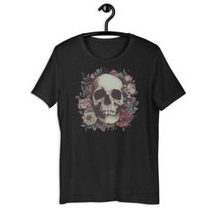 Skull Floral - Everyone needs the perfect t-shirt to complement an everyday, laid-back look. The ideal top for so many occasions, this lightweight cotton tee will keep you comfy and looking smart. * 100% combed and ring-spun cotton (Heather colors contain polyester) * Fabric weight: 4.2 oz/yd² (142 g/m²) * Pre-shrunk fabric * Side-seamed construction * Shoulder-to-shoulder taping * Blank product sourced from Guatemala, Nicaragua, Mexico, Honduras, or the US This product is made especially for yo Black Skull T-shirt With Relaxed Fit, Punk Skull Print T-shirt For Summer, Edgy Skull Print Relaxed Fit T-shirt, Cotton Grunge T-shirt With Skull Print, Punk Skull T-shirt For Summer, Summer Punk Skull T-shirt, Edgy Relaxed Fit T-shirt With Skull Print, Summer Punk T-shirt With Skull Design, Edgy Cotton T-shirt With Skull Print