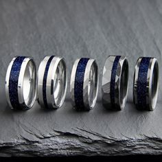 "These beautiful blue Sandstone / goldstone rings have a strong presence and appears like you're looking deep into space or the night. This ring is great as a men's engagement ring, women's wedding band, or promise ring. Great gift for him or her! Why buy from us? We do our best to make the ring buying process simple and easy for you. With this ring we include: ** Made With Love ** ** Lots of positive 5 star reviews ** ** FREE 1 Year Limited Warranty (See FAQ) ** ** A portion of the sale goes to support charity ** Buy with confidence knowing we will do everything we can to make sure you're happy with the purchase :) || Features || - Multiple styles options ( If you see an option not listed please reach out as it may be able to be created ) - 4mm / 8mm width ( other widths available upon re Rings Multiple, Blue Sandstone, Buying Process, Blue Goldstone, Ring Men, Engagement Rings For Men, Womens Wedding Bands, Ring Collections, Promise Ring