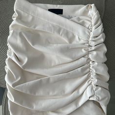 the back of a white dress with ruffles on it