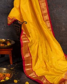 "Experience the thrill of wearing our Pure Silk Paithani, handloomed using traditional techniques. Embrace the vibrant yellow color and feel the authenticity of the intricate weaving. Own a piece of history and add a touch of luxury to your wardrobe." Yellow Art Silk Traditional Wear For Transitional Season, Transitional Yellow Art Silk Traditional Wear, Transitional Season Yellow Dupatta With Traditional Drape, Yellow Raw Silk Traditional Wear For Navratri, Yellow Raw Silk Traditional Wear With Cutdana, Paithani Silk Traditional Wear With Handloom Drape, Handloom Paithani Silk Traditional Wear, Yellow Traditional Wear With Cutdana, Yellow Dupatta For Puja And Transitional Season